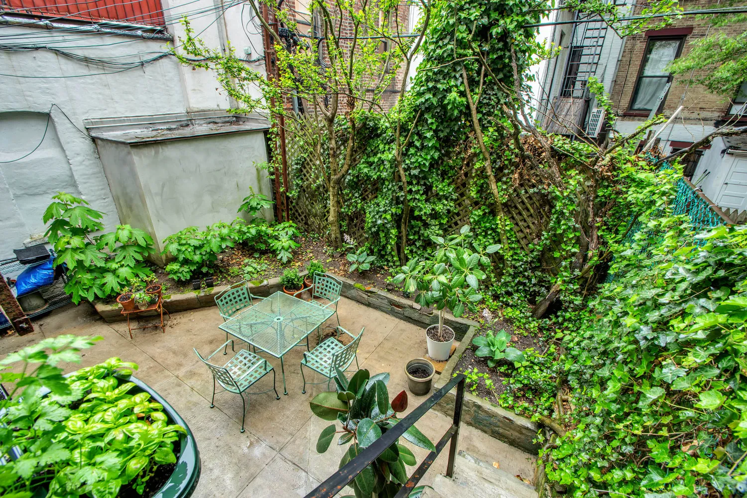 a backyard with potted plants and a bench