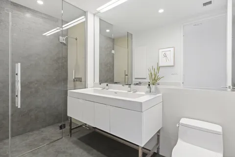a bathroom with a sink toilet and shower