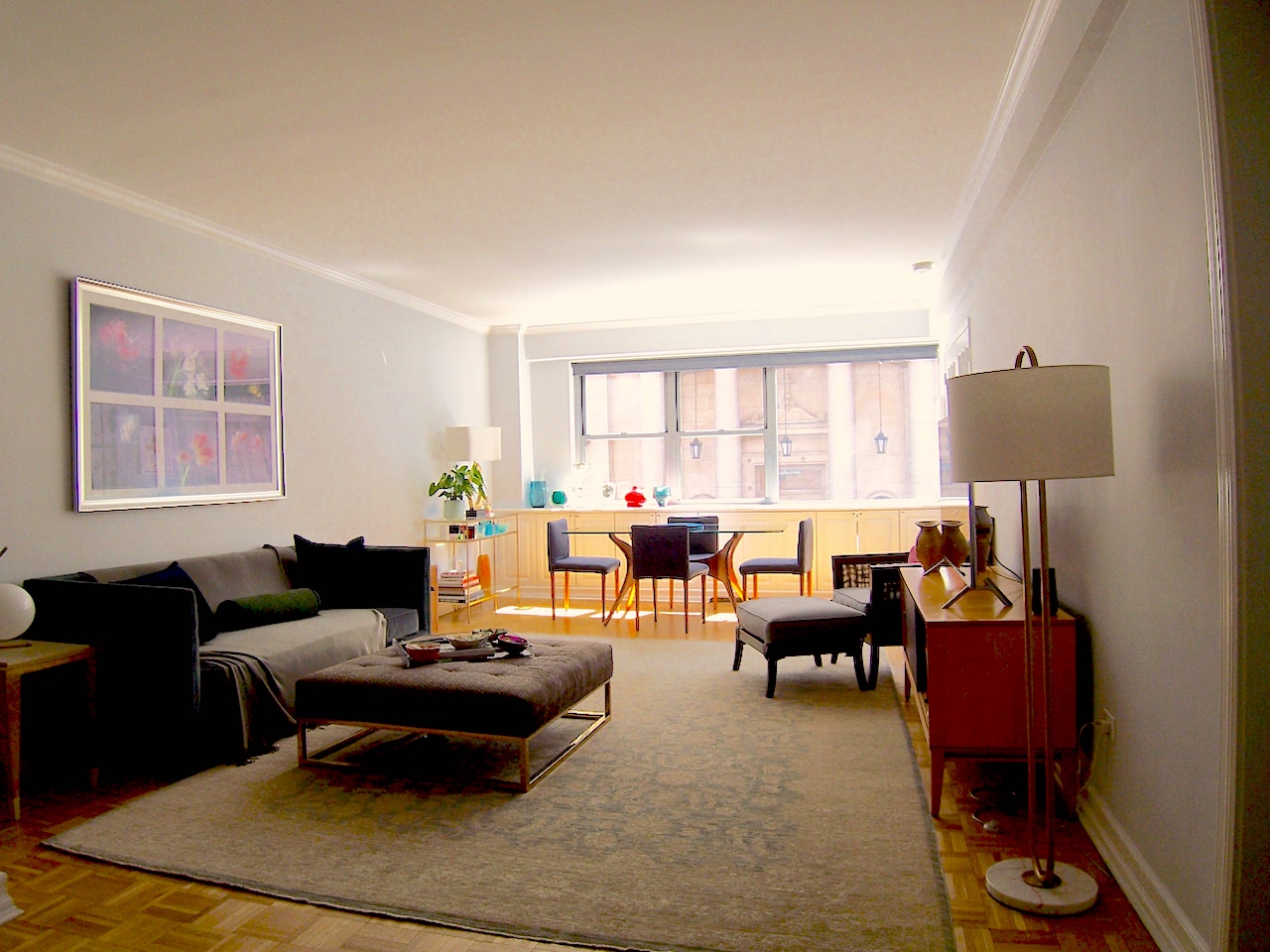 136 East 76th Street, Unit 3E Manhattan, NY 10021 - Photo 2 of 11 a living room with furniture and a large window