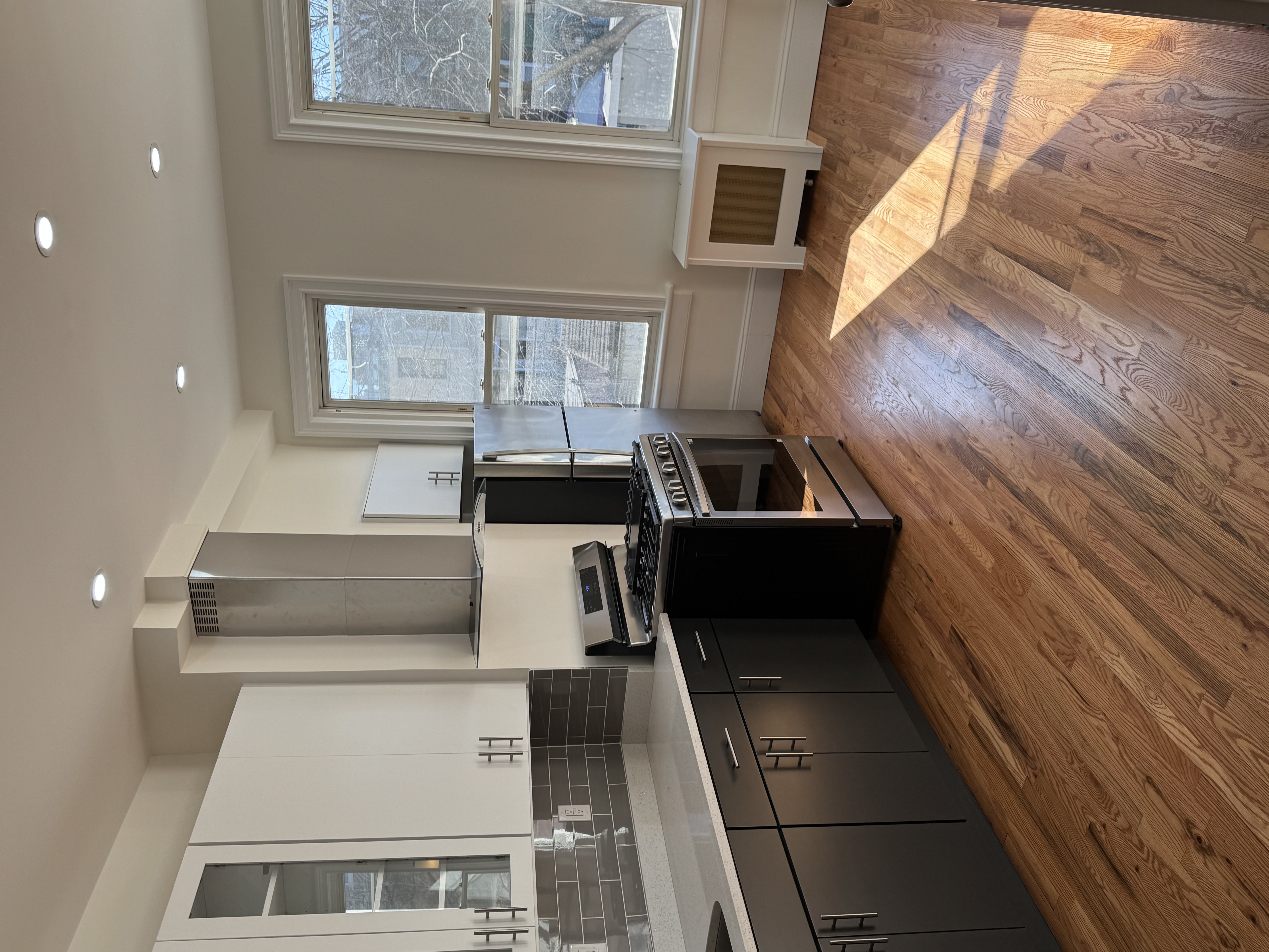 a kitchen with stainless steel appliances granite countertop a stove a sink and a microwave