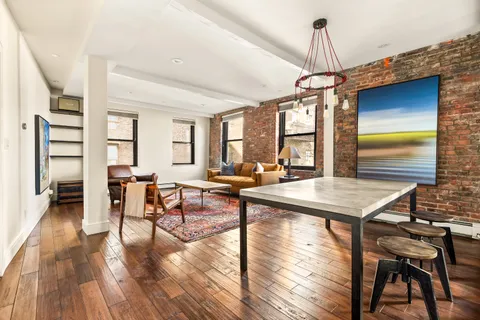 a room with lots of furniture and wooden floor