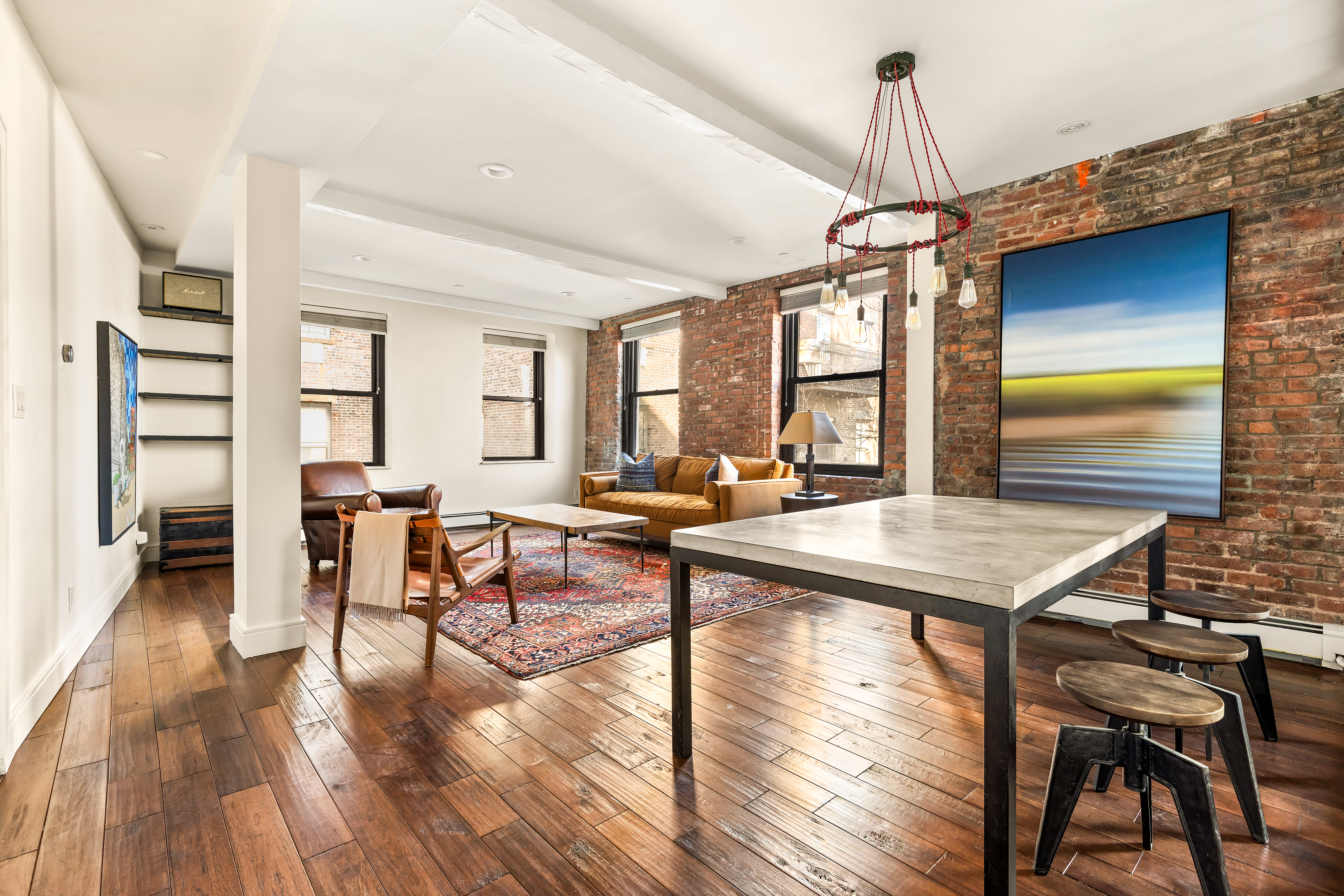 264 Water Street, Unit 6C Manhattan, NY 10038 - Photo 5 of 9 a room with lots of furniture and wooden floor