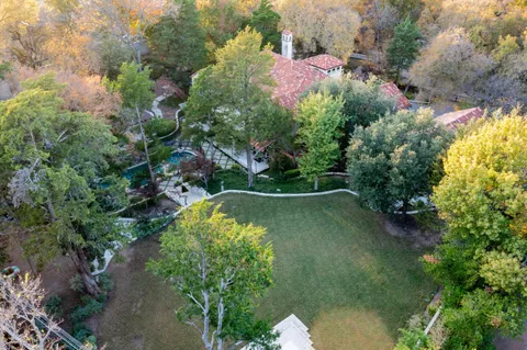 an aerial view of a house with a yard