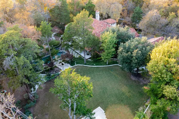 an aerial view of a house with a yard