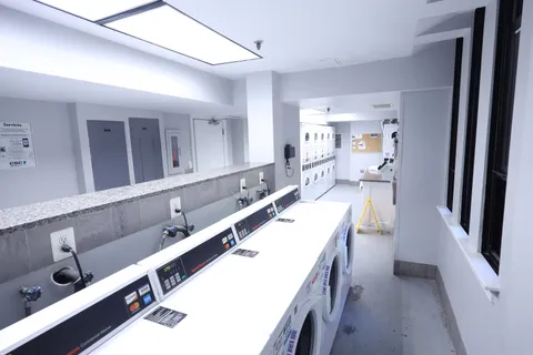 a large bathroom with a double vanity sink a mirror and a shower