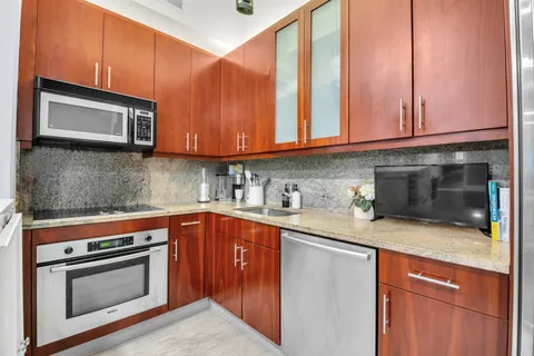 a kitchen with stainless steel appliances granite countertop a sink stove and microwave