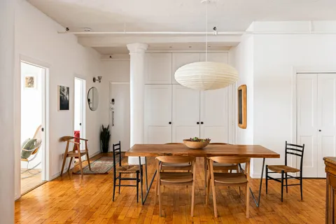 a view of a dining room with furniture and wooden floor