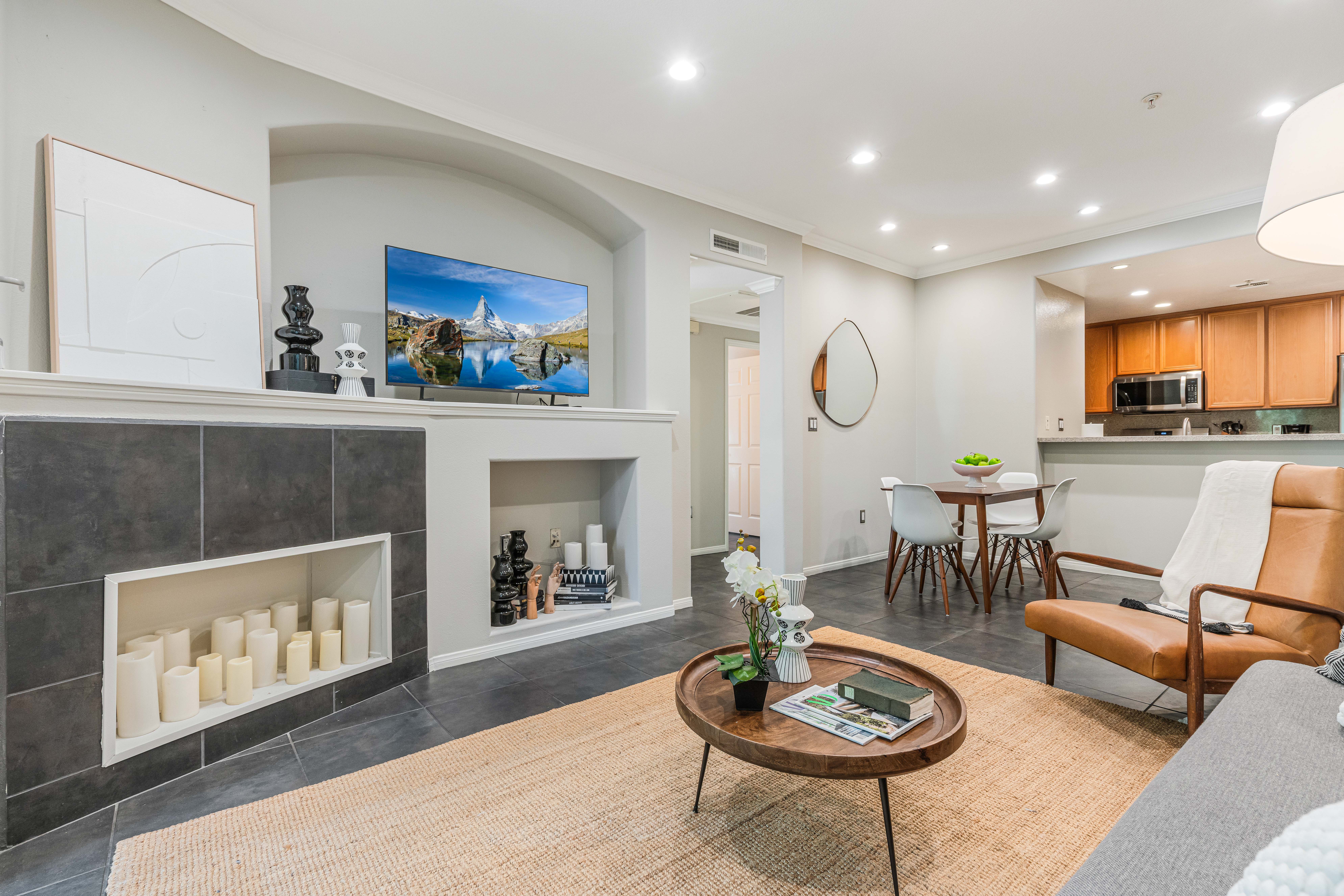 12963 West Runway Road Playa Vista, CA 90094 - Photo 4 of 39 a living room with furniture a rug and a fireplace