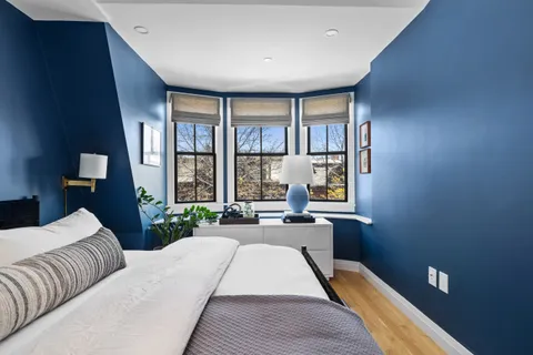 a bed room with a bed and a large window