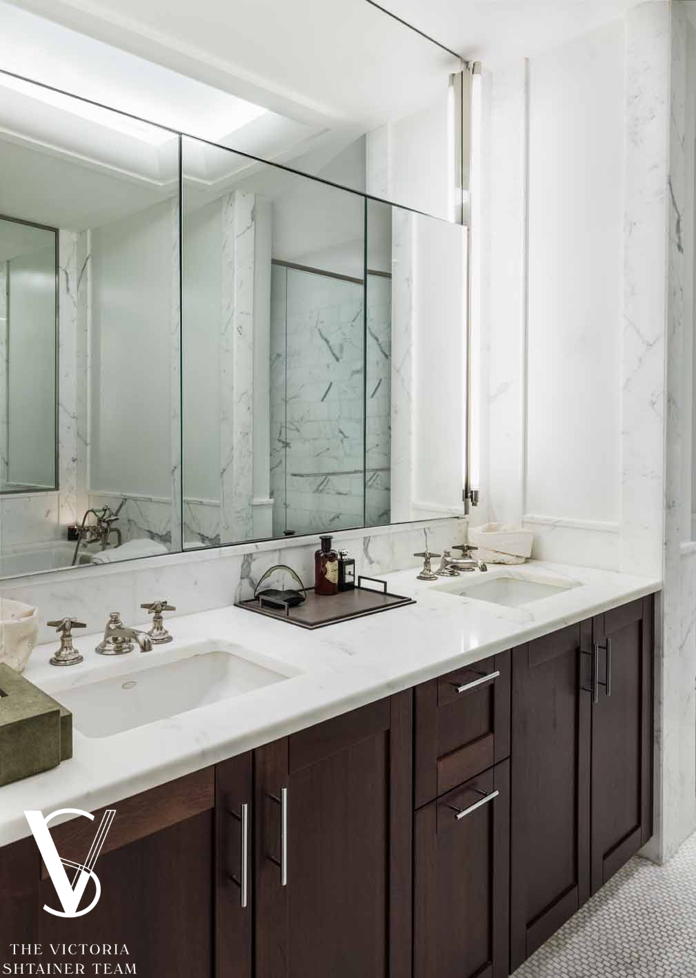151 East 58th Street, Unit 38A Manhattan, NY 10022 - Photo 7 of 13 a bathroom with a sink and a mirror