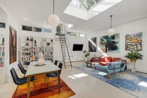 a living room with patio furniture and a flat screen tv