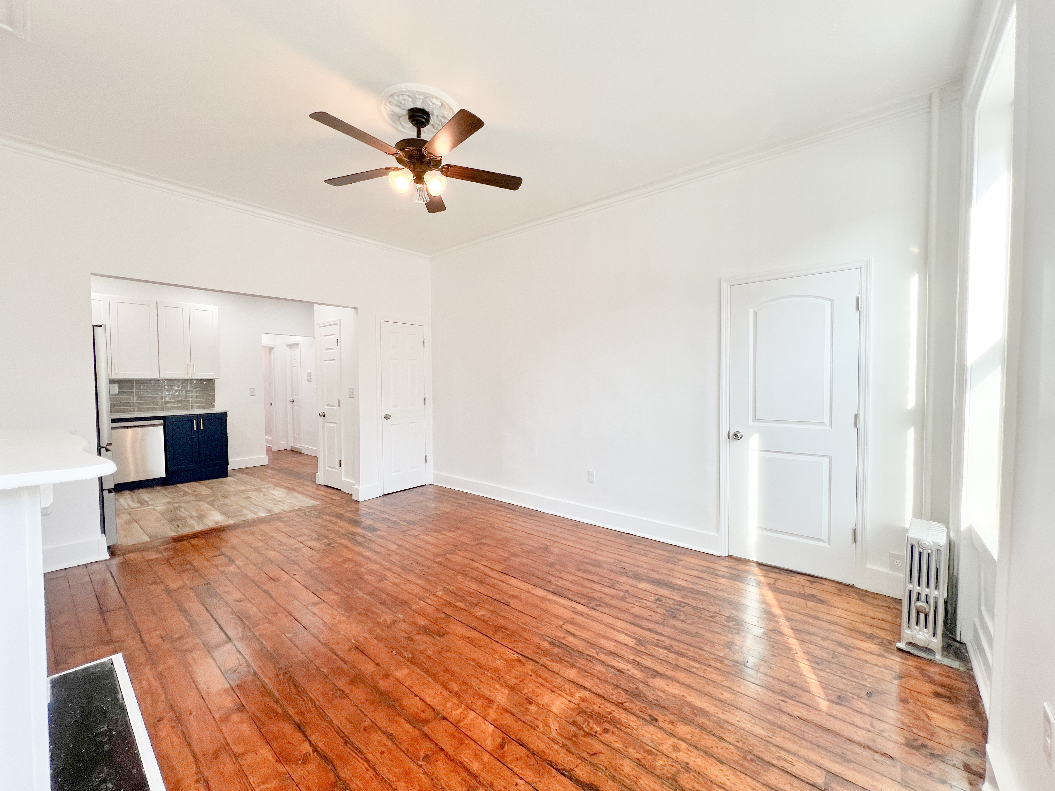 556 Vanderbilt Avenue, Unit 2 Brooklyn, NY 11238 - Photo 4 of 14 a view of empty room with wooden floor and ceiling fan