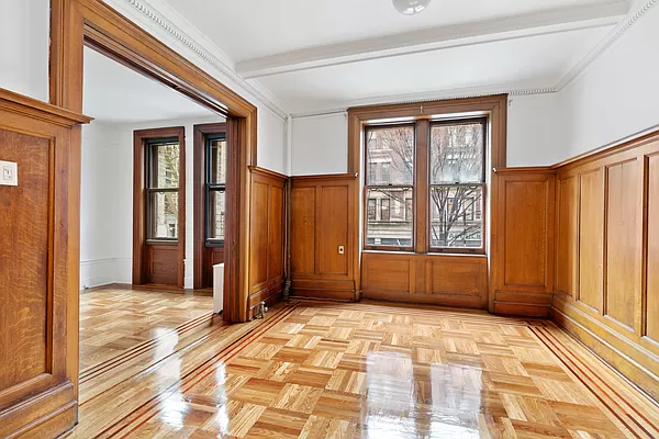 50 East 96th Street, Unit 2A Manhattan, NY 10128 - Photo 2 of 7 a view of a bedroom with wooden floor and windows