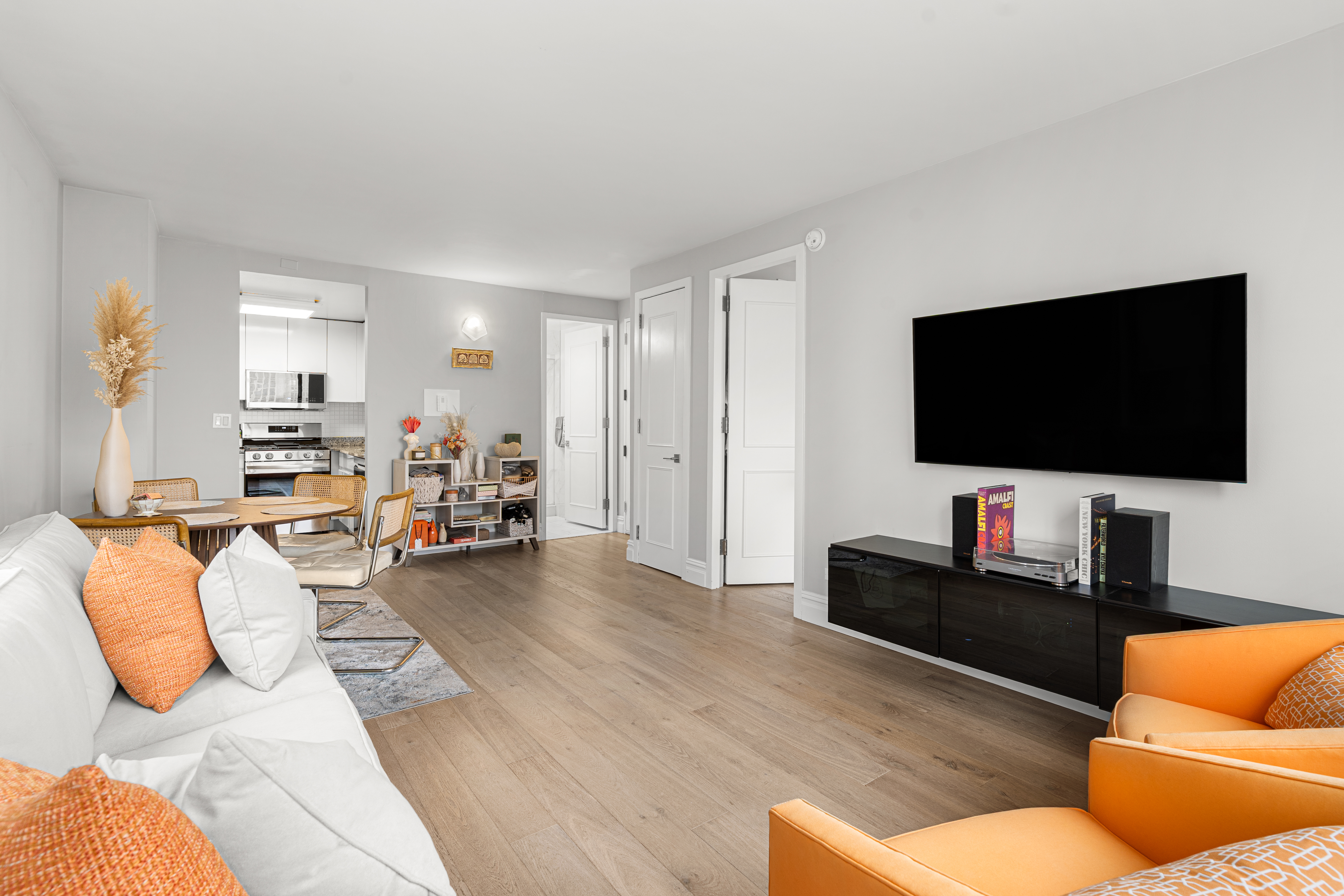 236 East 47th Street, Unit 17C Manhattan, NY 10017 - Photo 6 of 11 a living room with furniture and a flat screen tv