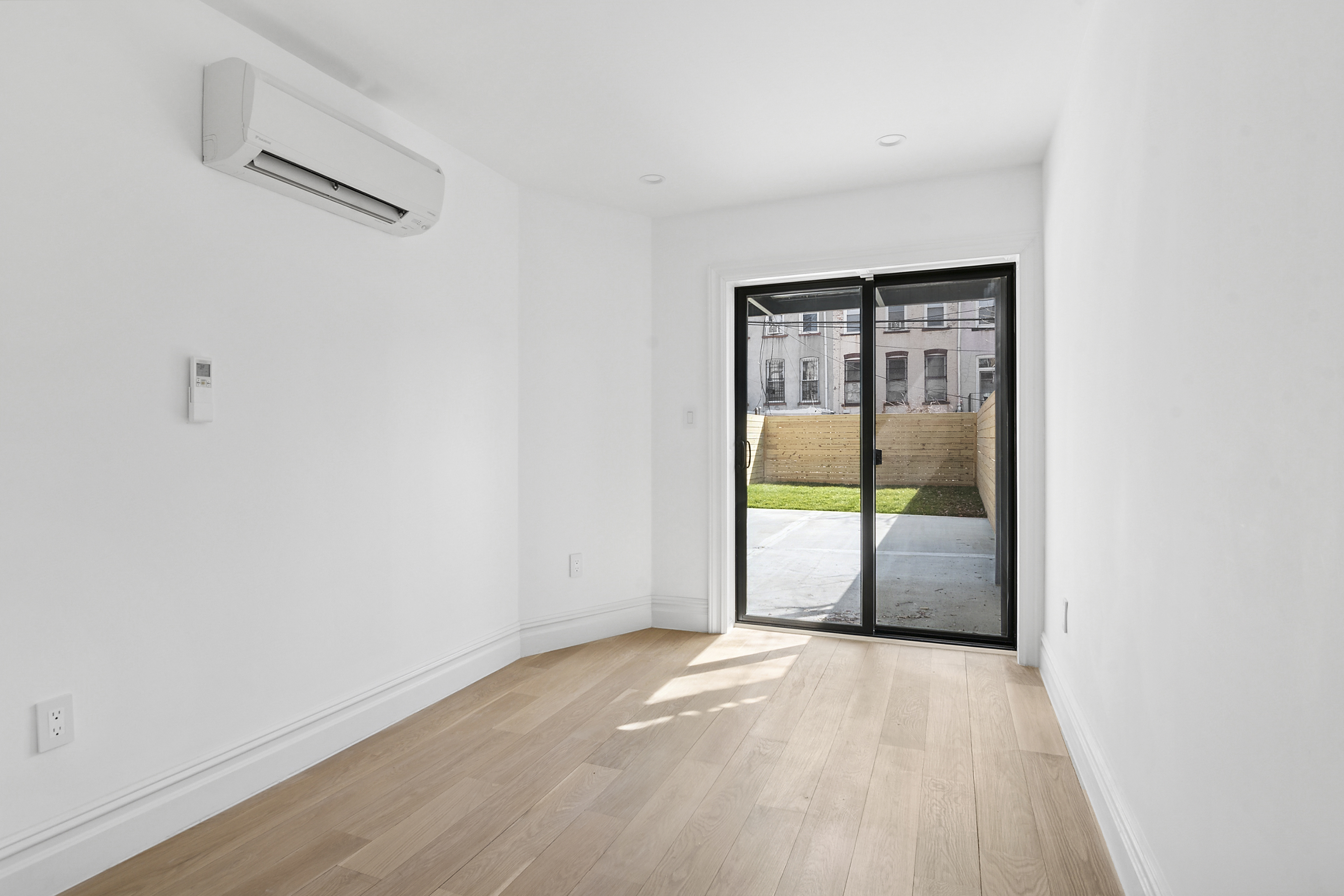 716 Decatur Street, Unit 1 Brooklyn, NY 11233 - Photo 4 of 7 an empty room with sliding glass door