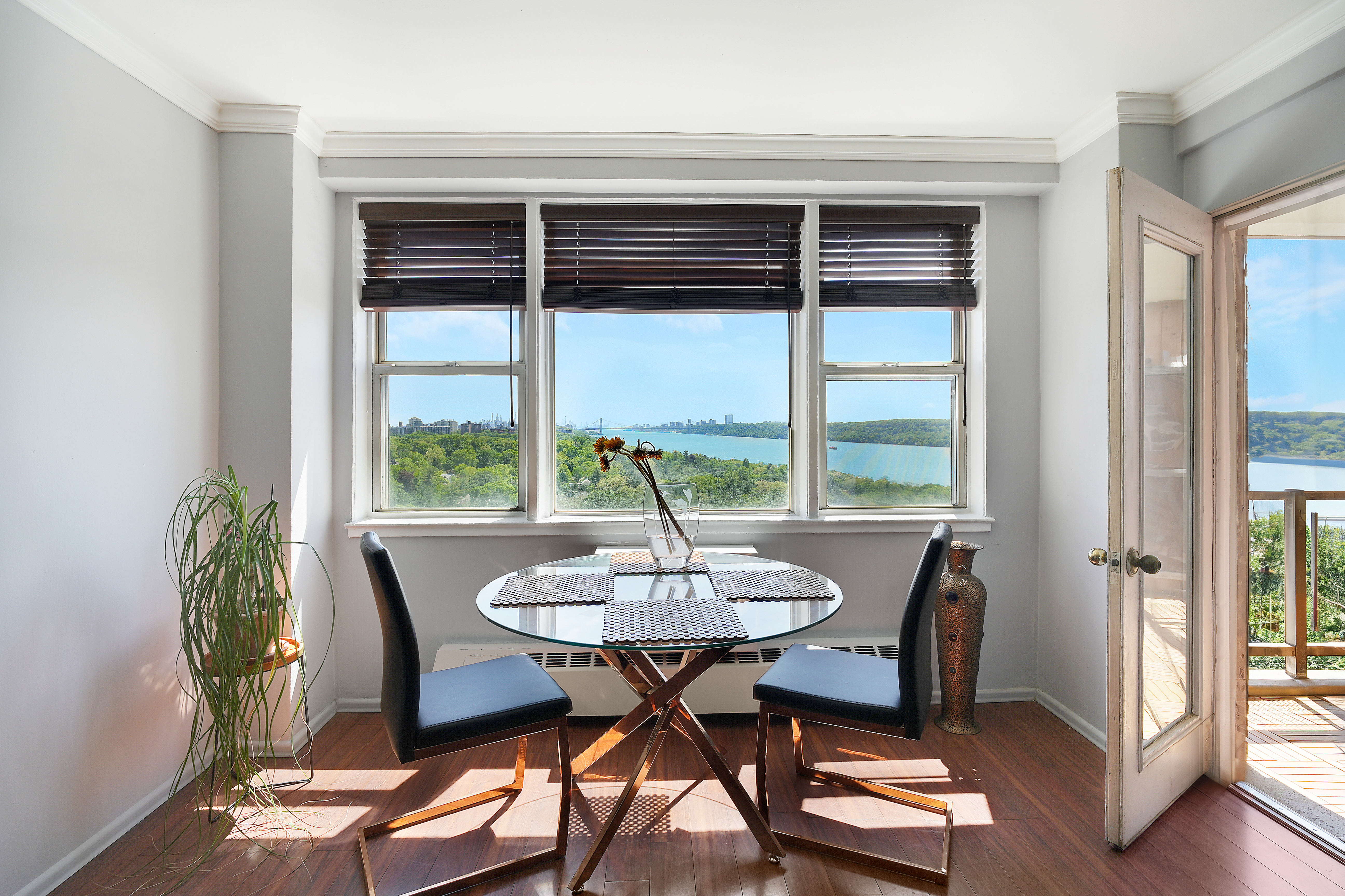 5700 Arlington Avenue, Unit 16T Bronx, NY 10471 - Photo 1 of 16 a view of a dining room with furniture and wooden floor