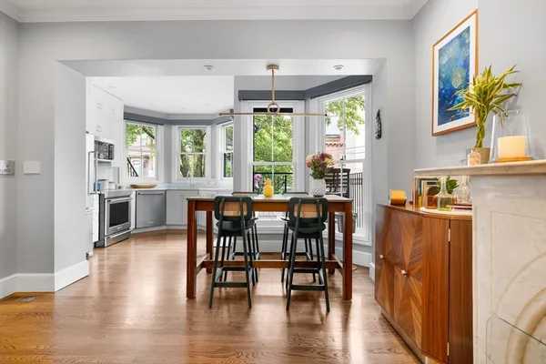 a view of a dining room with furniture window and wooden floor
