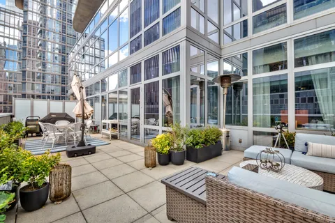 a view of a patio with couches and potted plants