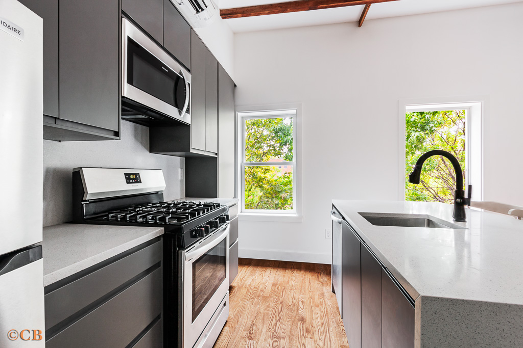221 Gates Avenue, Unit 2 Brooklyn, NY 11238 - Photo 2 of 7 a kitchen with stainless steel appliances a stove a sink and a microwave