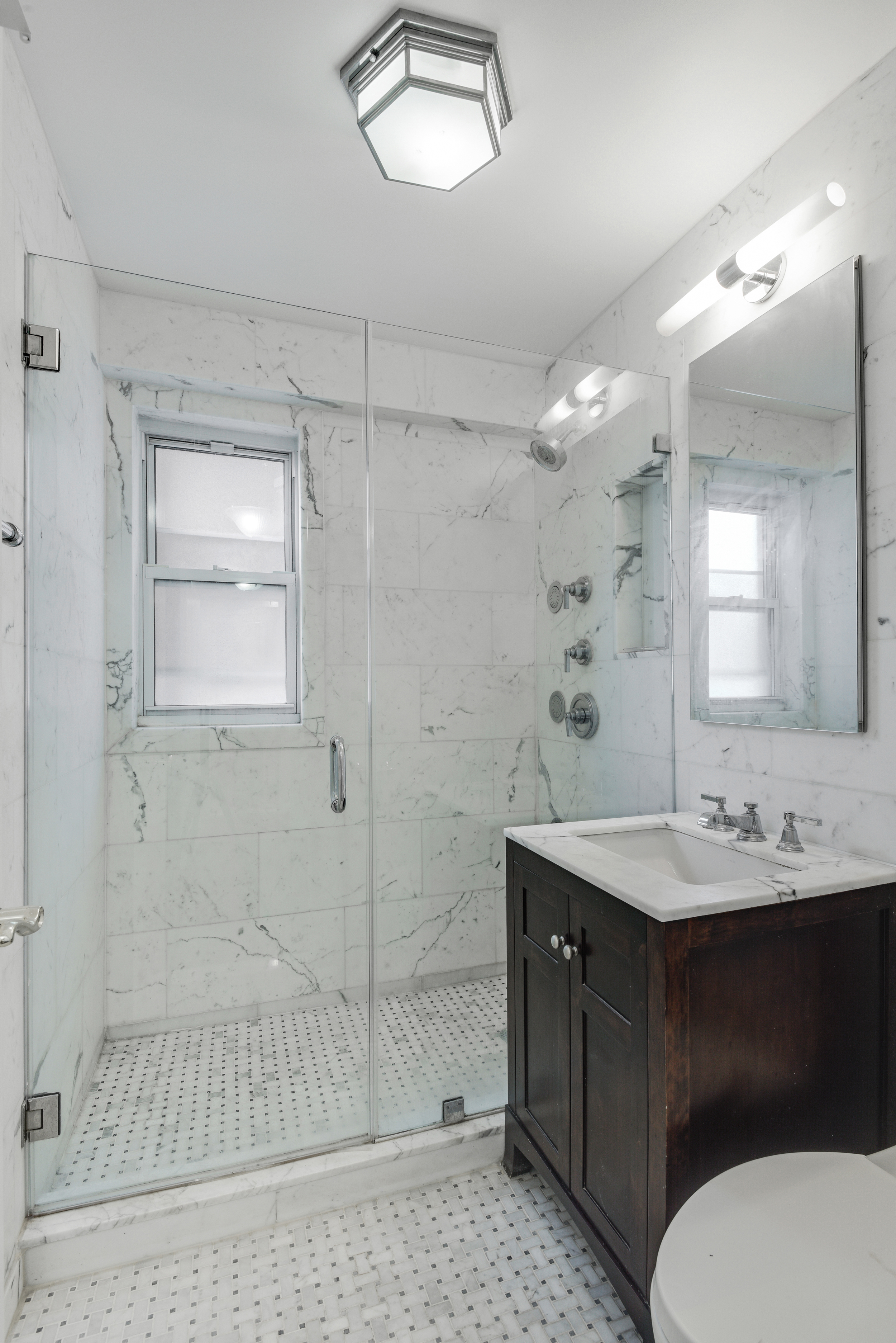 16 Sutton Place, Unit 2B Manhattan, NY 10022 - Photo 8 of 20 a bathroom with a sink a toilet and shower
