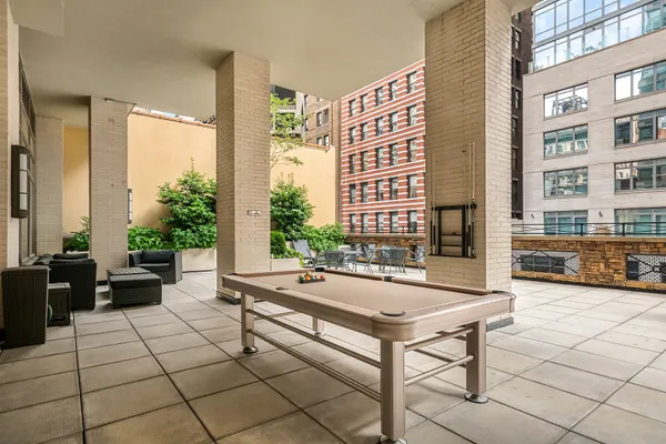 a living room with furniture and large windows