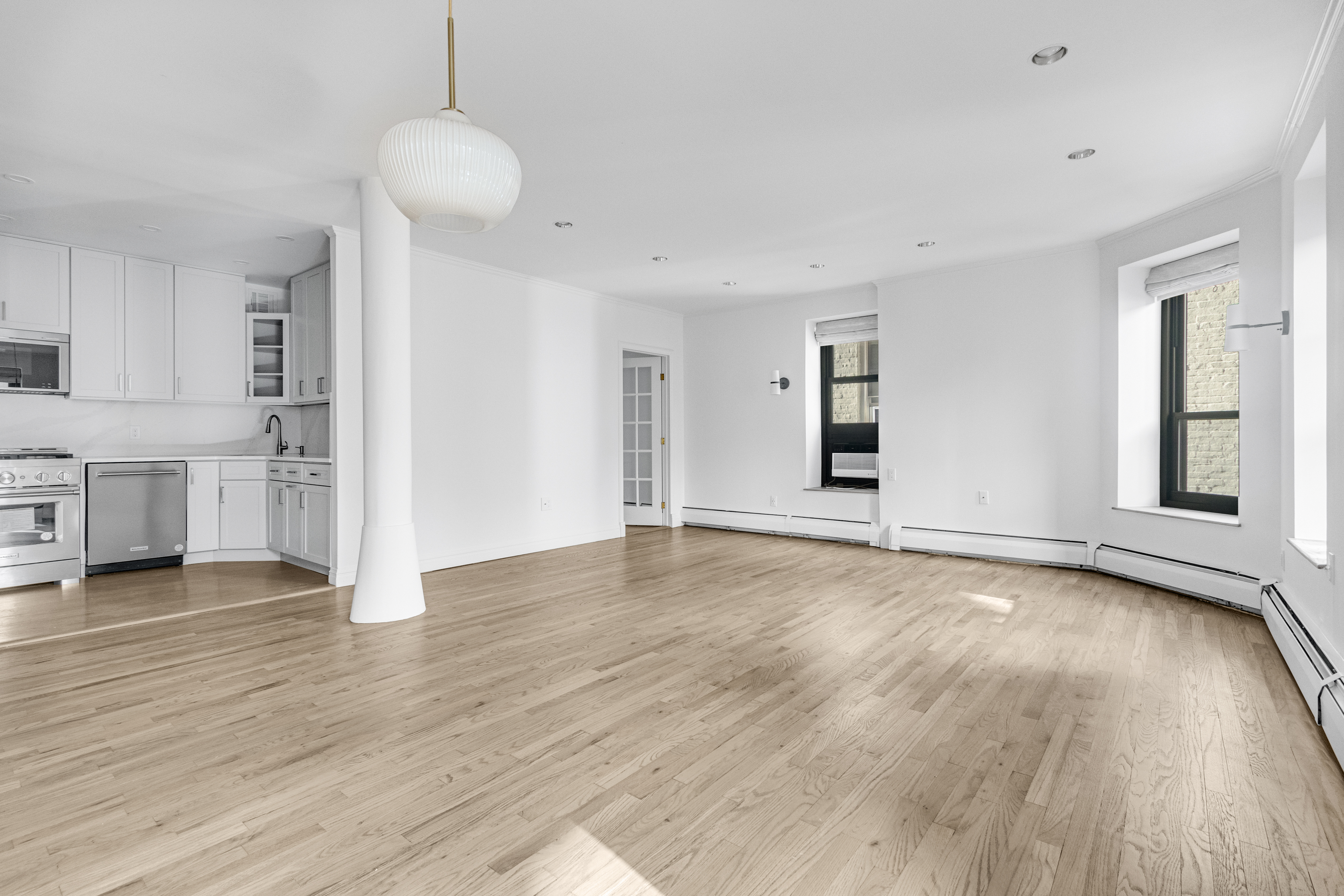 305 West 98th Street, Unit 7CS Manhattan, NY 10025 - Photo 4 of 18 a view of empty room with wooden floor and window