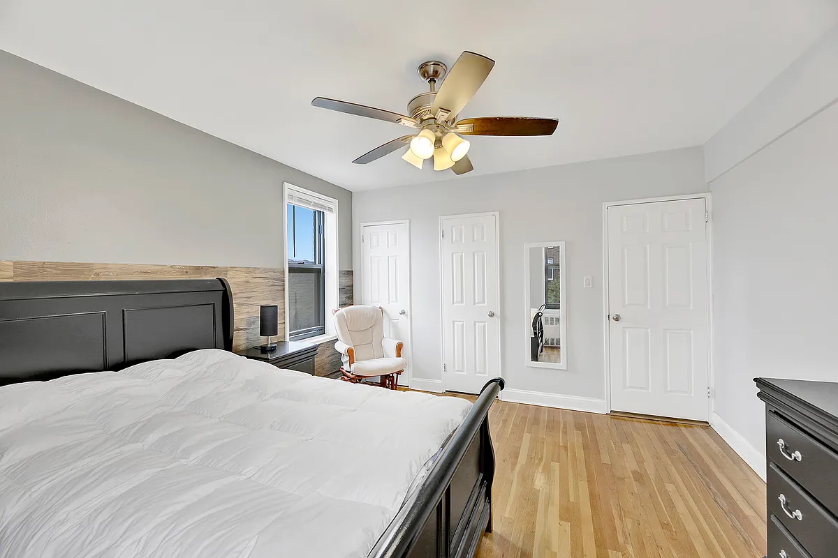 9040 Fort Hamilton Parkway, Unit 4G Brooklyn, NY 11209 - Photo 8 of 12 a bedroom with a bed and a chandelier