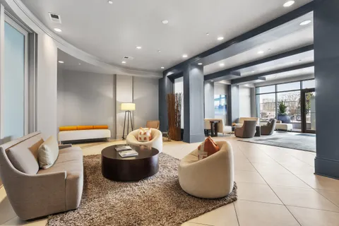 a large hall with furniture and a large mirror