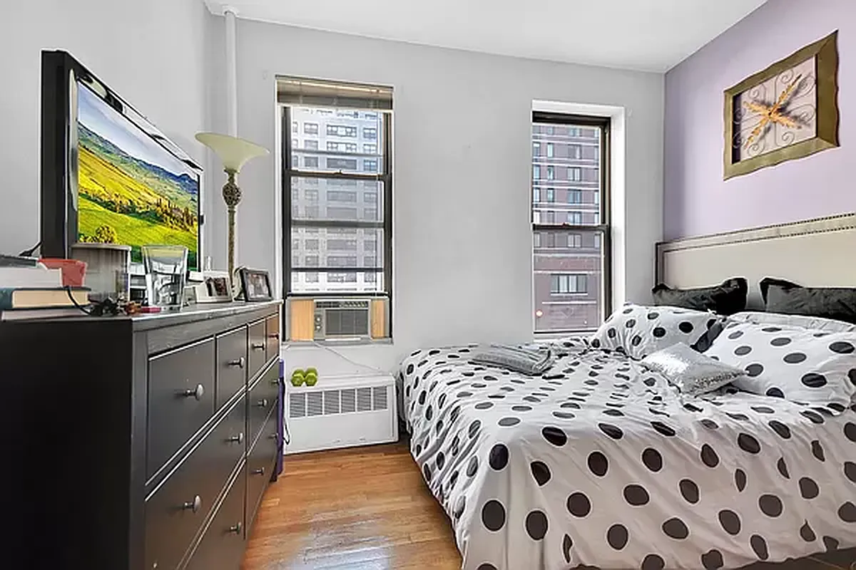 416 East 71st Street, Unit 17 Manhattan, NY 10021 - Photo 2 of 8 a bedroom with a bed and a window
