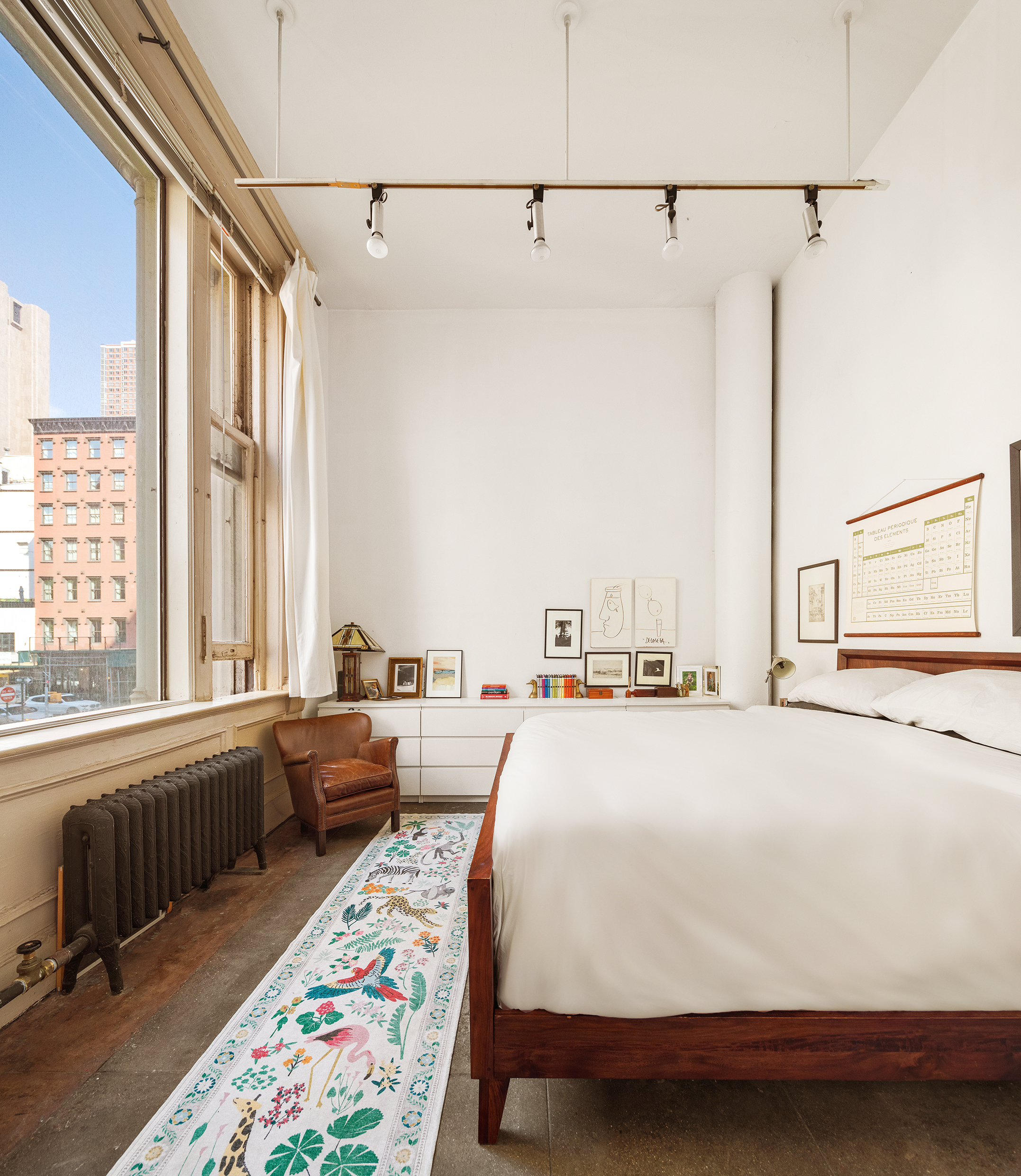 90 West Broadway, Unit 2B Manhattan, NY 10007 - Photo 5 of 12 a bed room with a bed and a large window