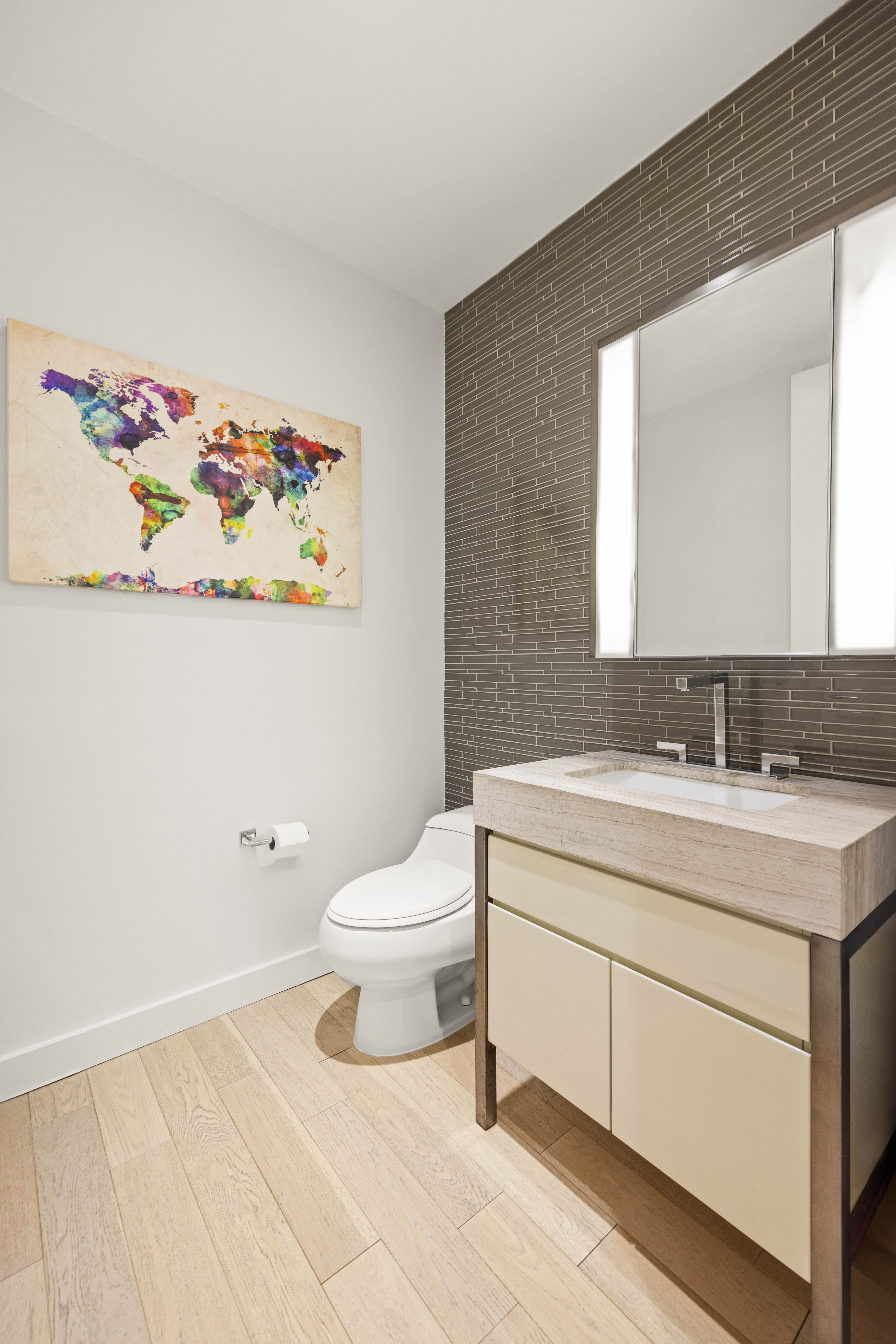 75 Wall Street, Unit 25K Manhattan, NY 10005 - Photo 8 of 9 a bathroom with a toilet sink and mirror