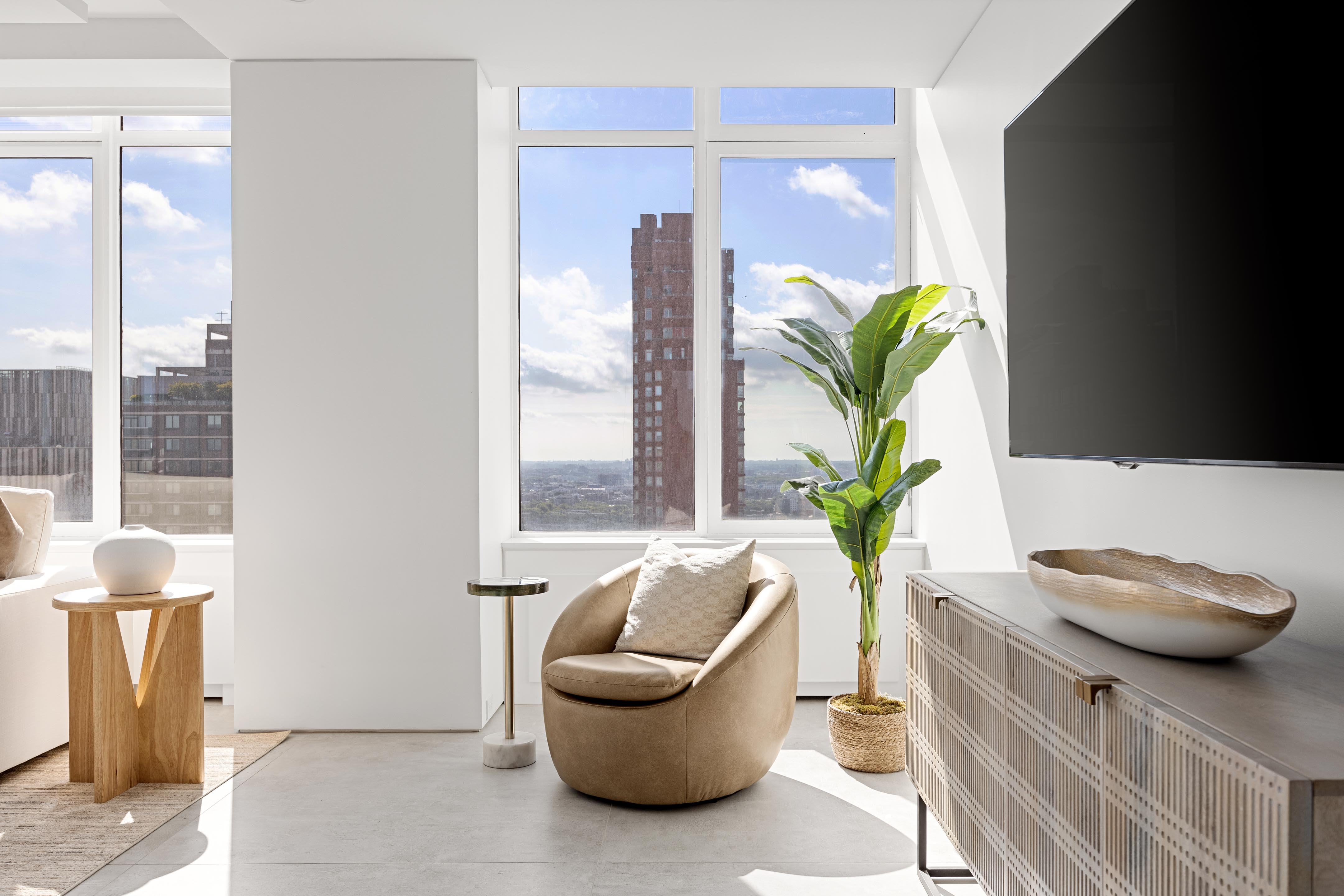 422 East 72nd Street, Unit 37AD Manhattan, NY 10021 - Photo 3 of 38 a living room with furniture and a potted plant
