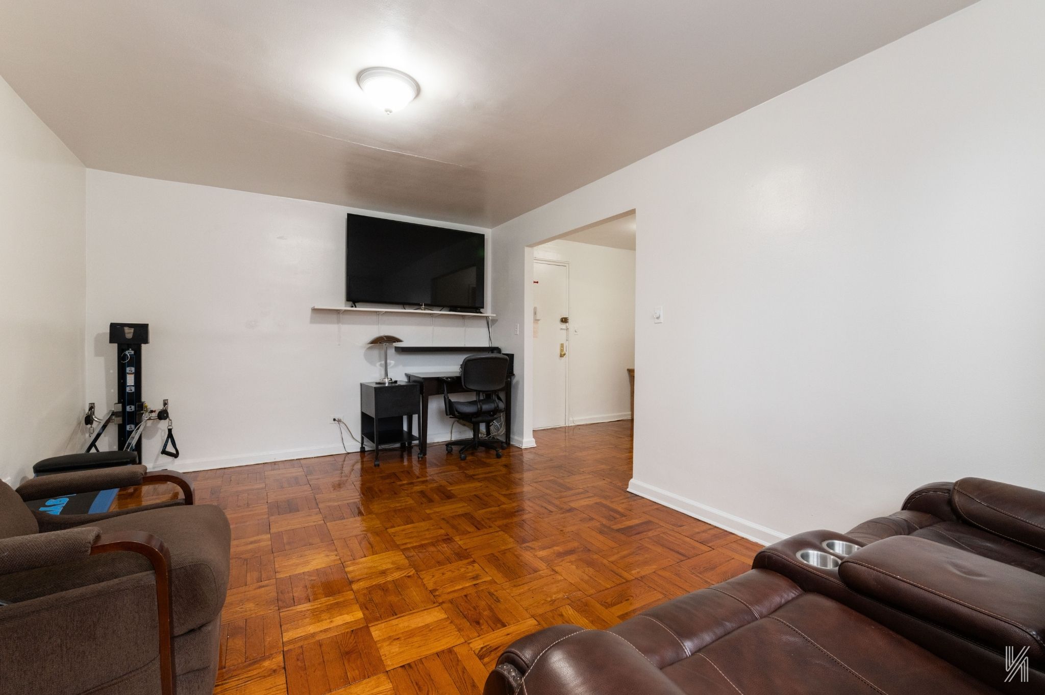 33-24 Junction Boulevard, Unit 1R Queens, NY 11372 - Photo 4 of 17 a living room with furniture and a flat screen tv