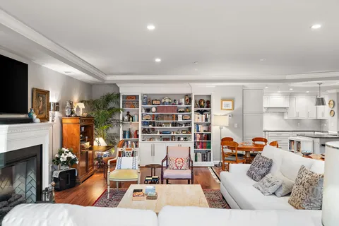a open kitchen with stainless steel appliances granite countertop a stove a sink dishwasher and cabinets with wooden floor