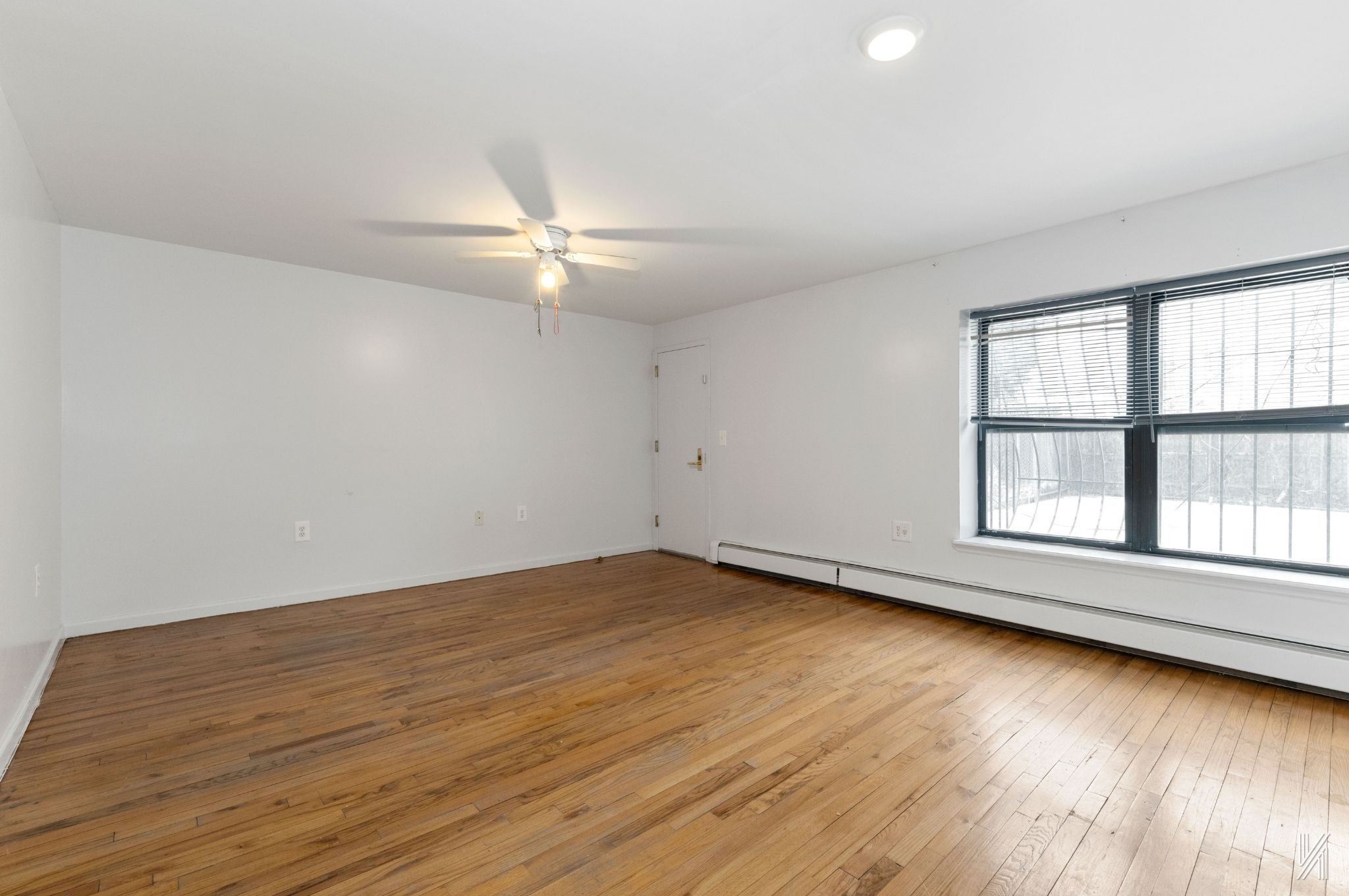 426 54th Street Brooklyn, NY 11220 - Photo 9 of 22 wooden floor in an empty room with a window
