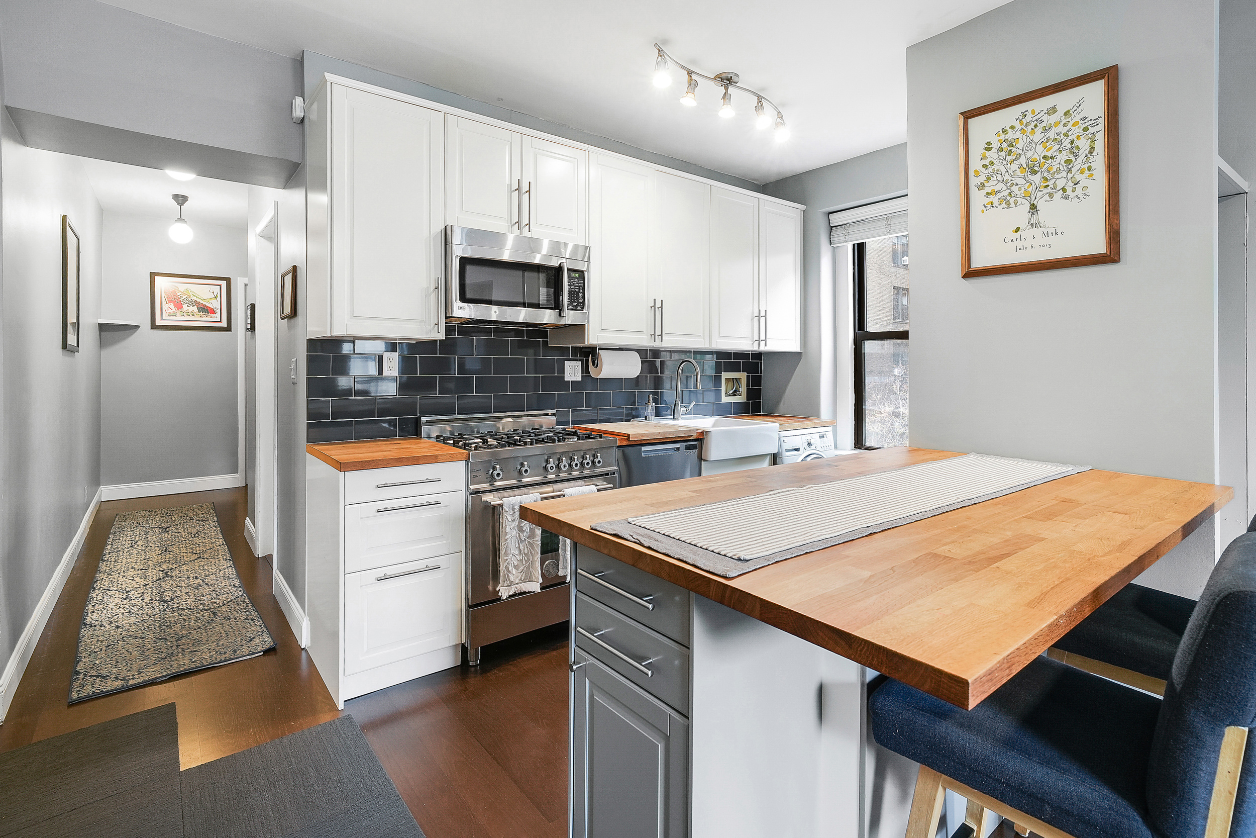 855 West End Avenue, Unit 4B Manhattan, NY 10025 - Photo 4 of 13 a kitchen with stainless steel appliances kitchen island a refrigerator sink and cabinets