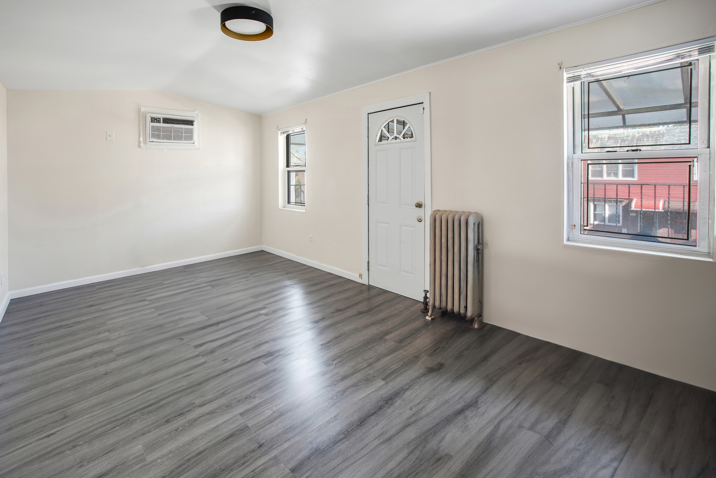 1532 Kimball Street Brooklyn, NY 11234 - Photo 2 of 13 an empty room with wooden floor and windows