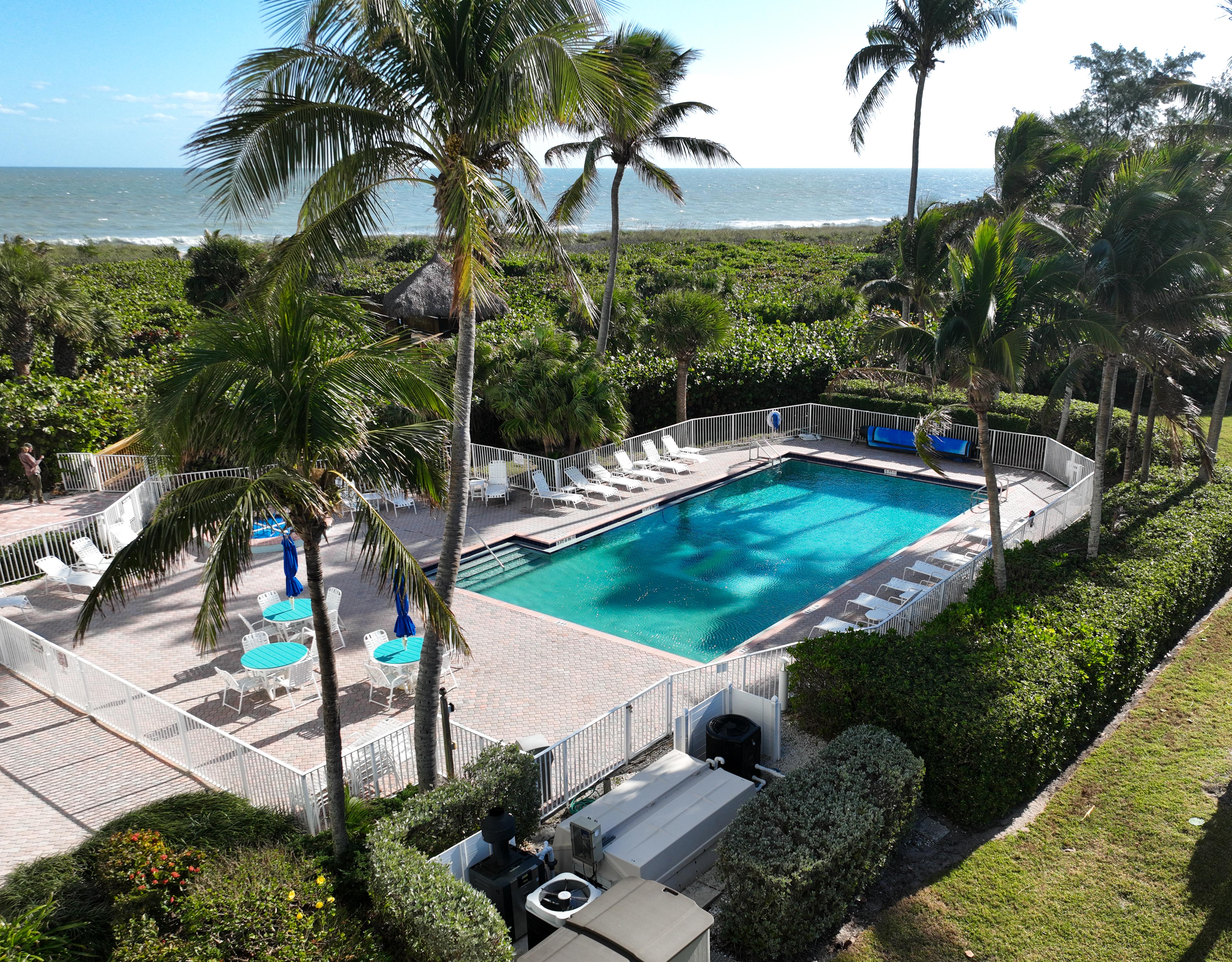 2700 North Highway A1a, Unit 207 Fort Pierce, FL 34949 - Photo 31 of 36 a view of a swimming pool with a patio and a garden