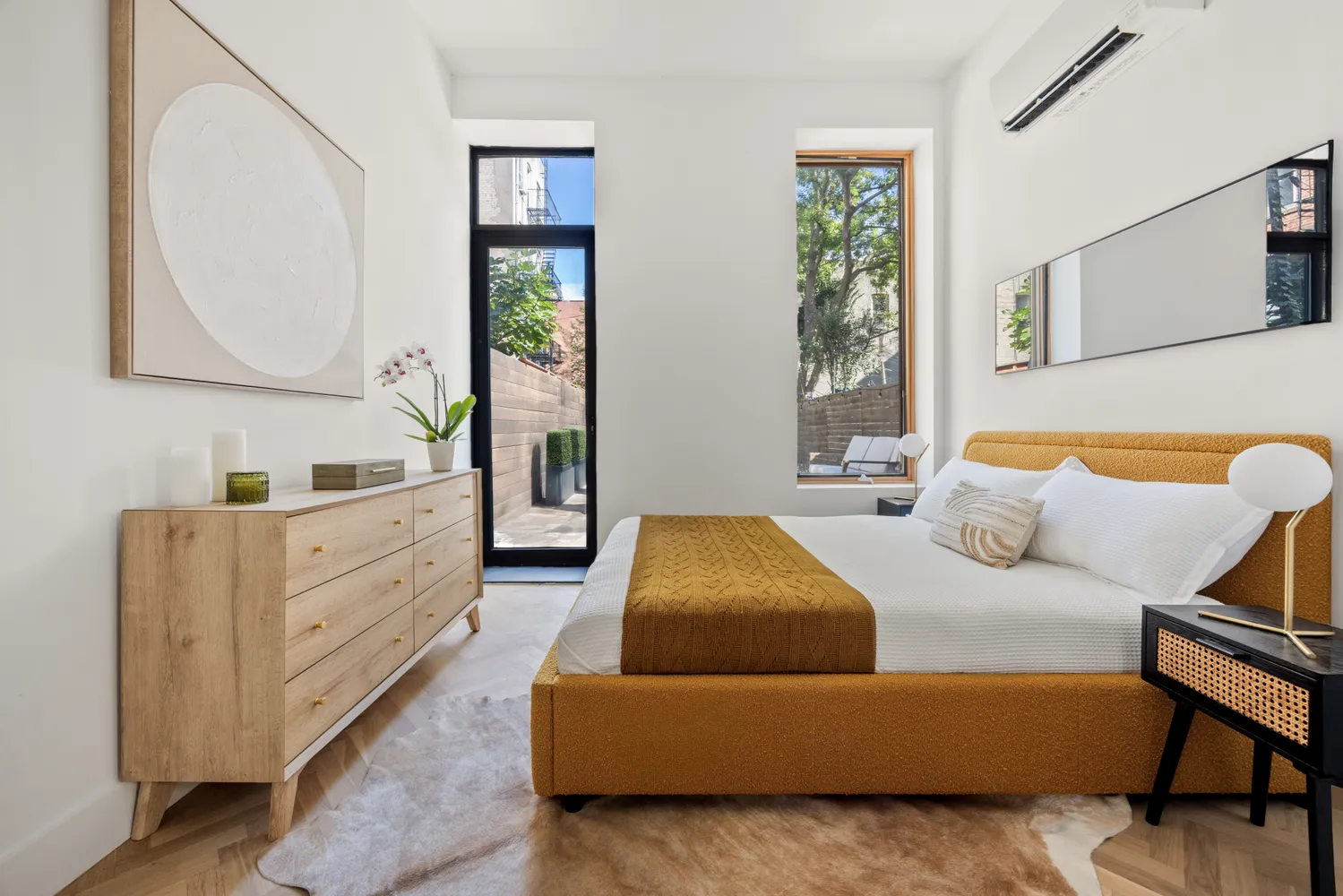 a bedroom with a bed and a dresser in it