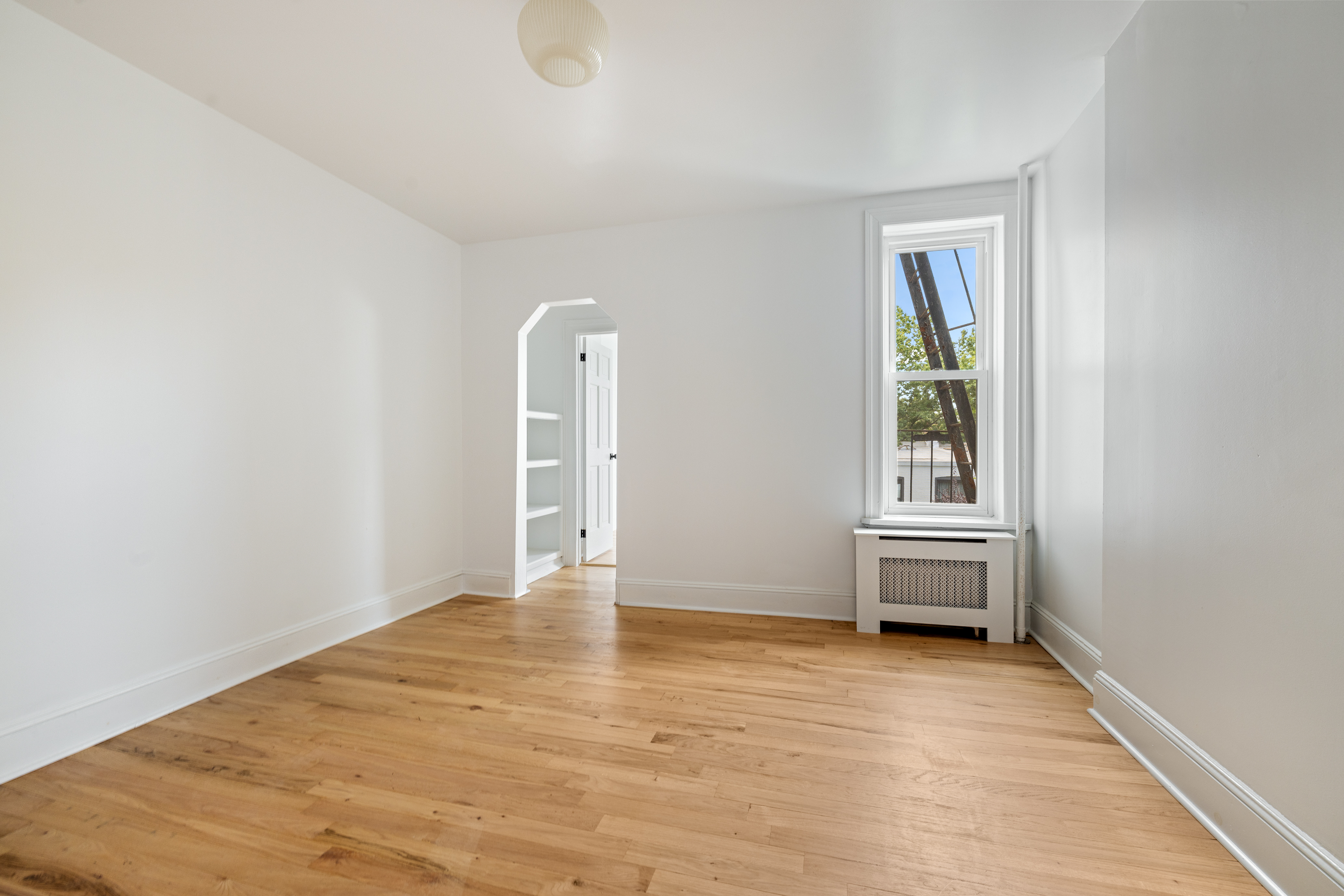 456 Prospect Avenue, Unit 3R Brooklyn, NY 11215 - Photo 8 of 16 a view of a livingroom with wooden floor and a window