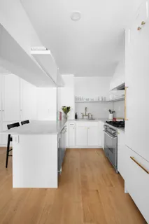 a kitchen with cabinets a sink and white appliances