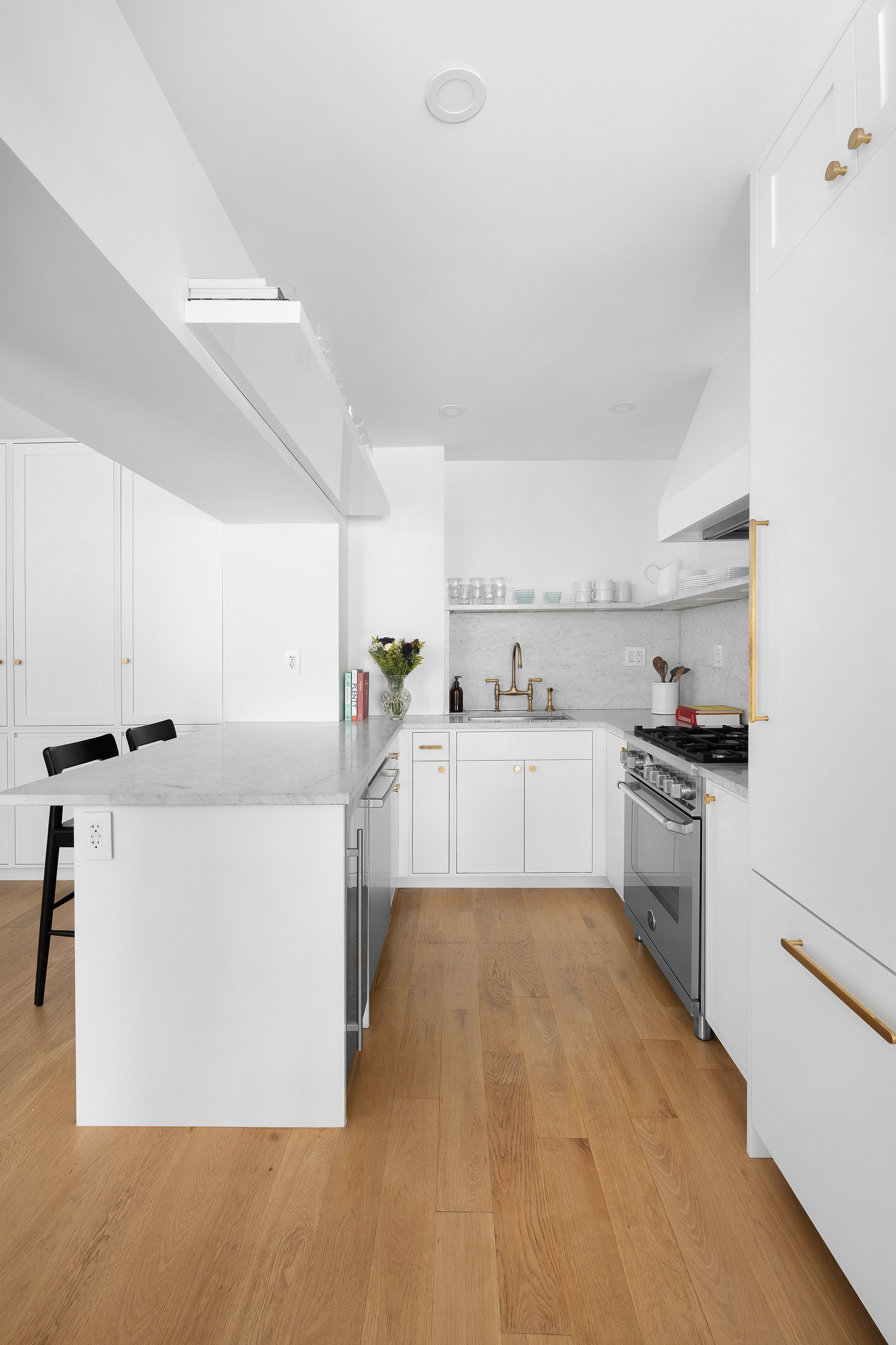 77 Bleecker Street, Unit 123E Manhattan, NY 10012 - Photo 4 of 13 a kitchen with cabinets a sink and white appliances