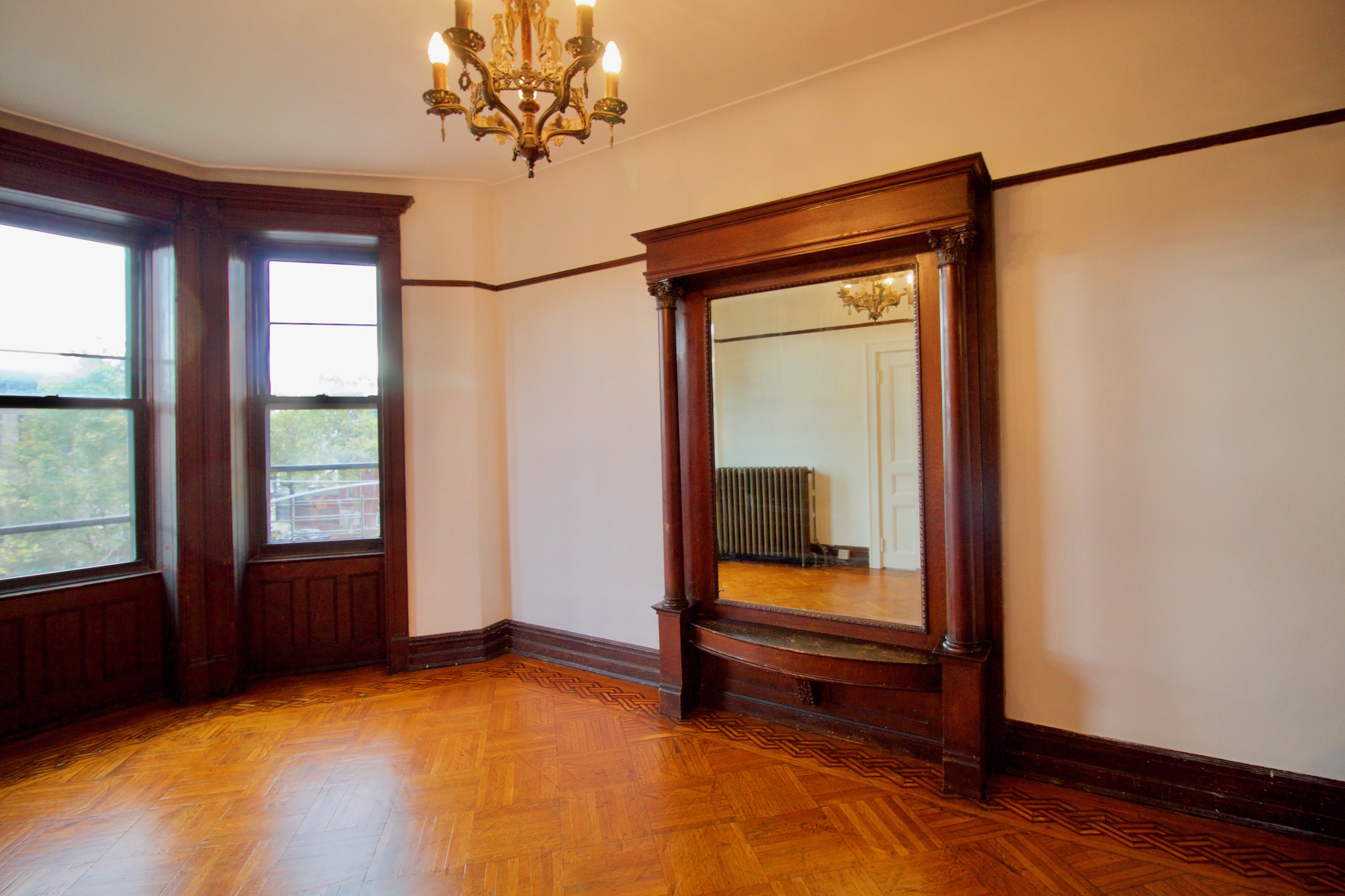 403 Caton Avenue, Unit 3 Brooklyn, NY 11218 - Photo 19 of 31 a view of an empty room with a window and wooden floor