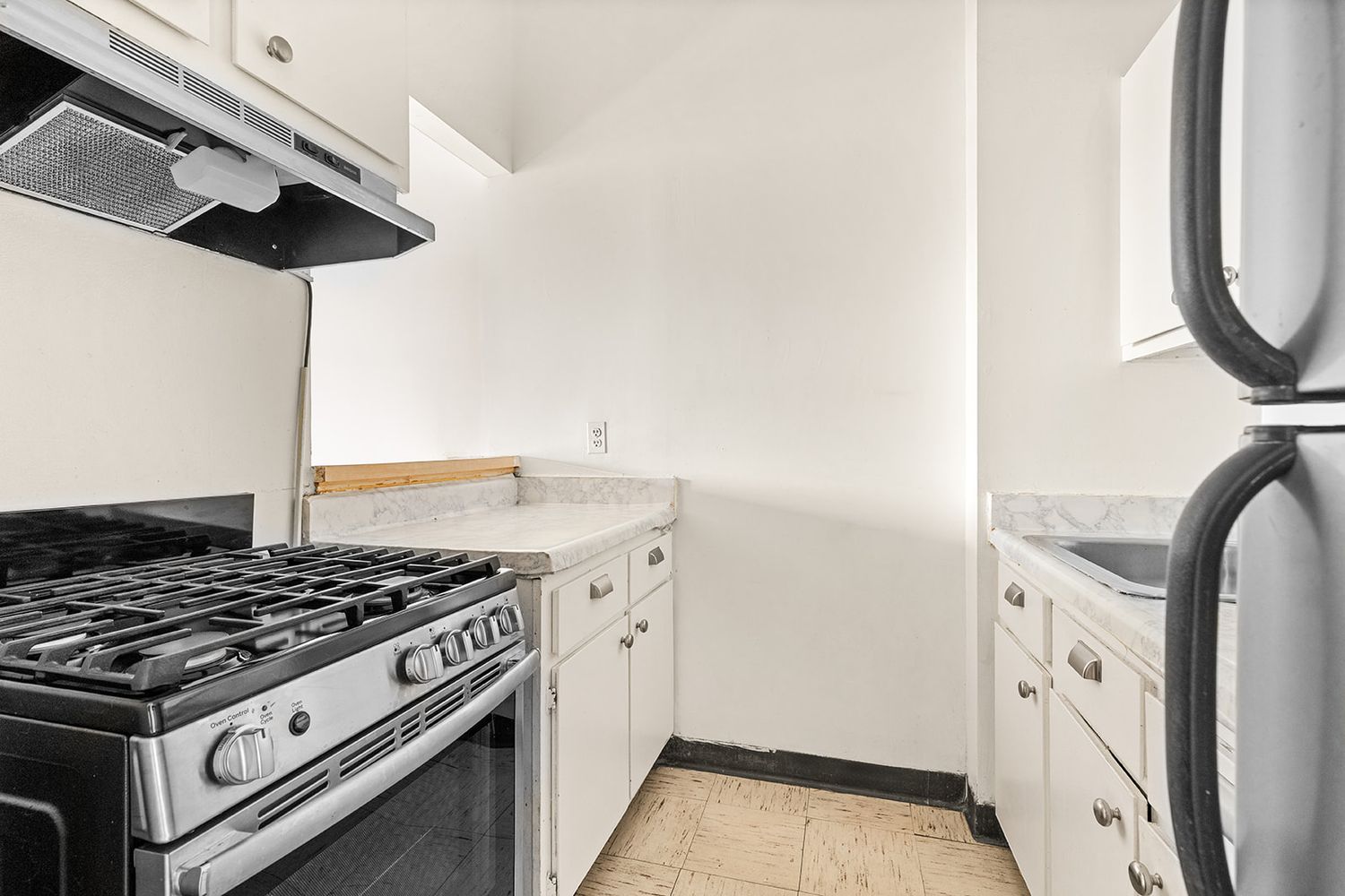 a stove top oven sitting inside of a kitchen