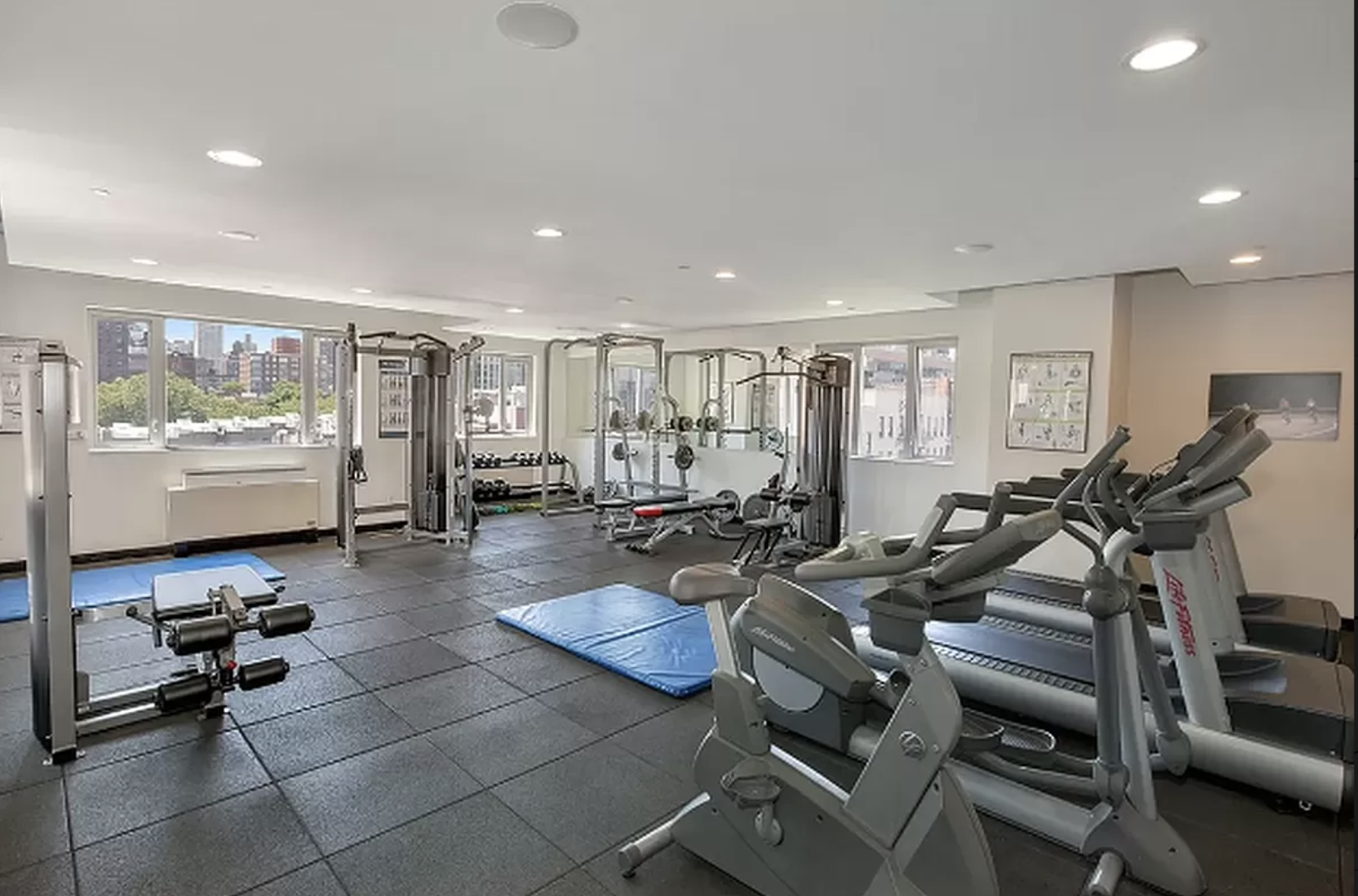 1810 3rd Avenue, Unit A7D Manhattan, NY 10029 - Photo 9 of 13 a room with gym equipment and a large window