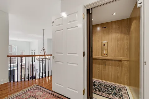 a view of an empty room with closet and a window