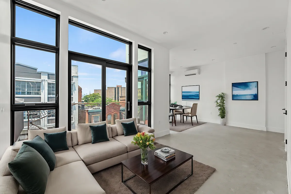 30 Belvidere Street, Unit PH4 Brooklyn, NY 11206 - Photo 1 of 8 a living room with furniture and a large window