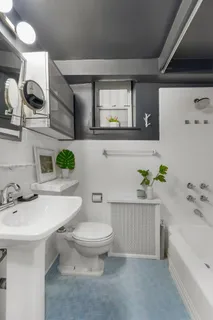 a bathroom with a sink mirror and toilet