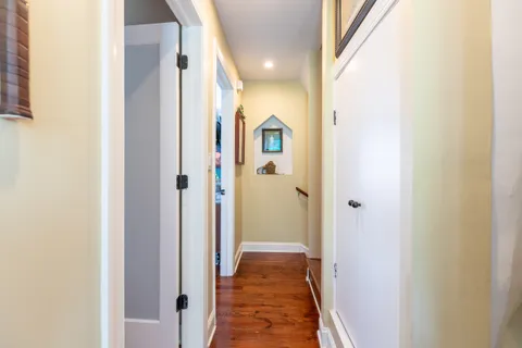 a view of a hallway with wooden floor