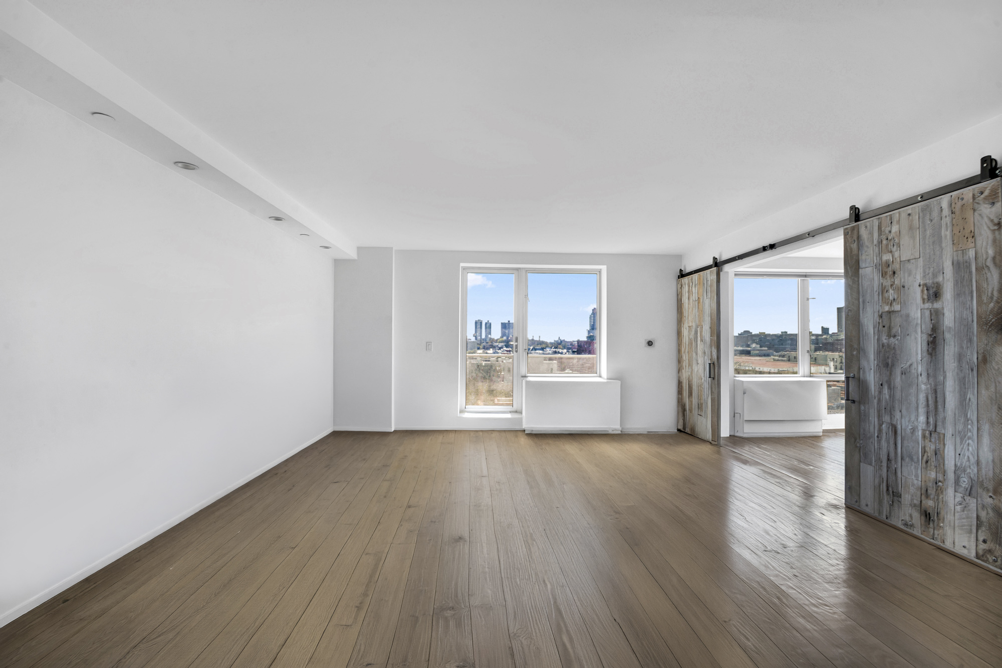 2280 Frederick Douglass Boulevard, Unit 10B Manhattan, NY 10027 - Photo 2 of 15 a view of a hardwood floor in a room with a sink and a window